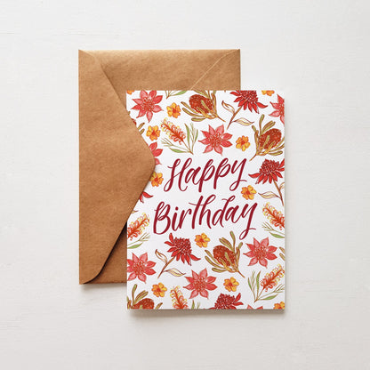 Happy birthday greeting card with red flowers and a brown envelope