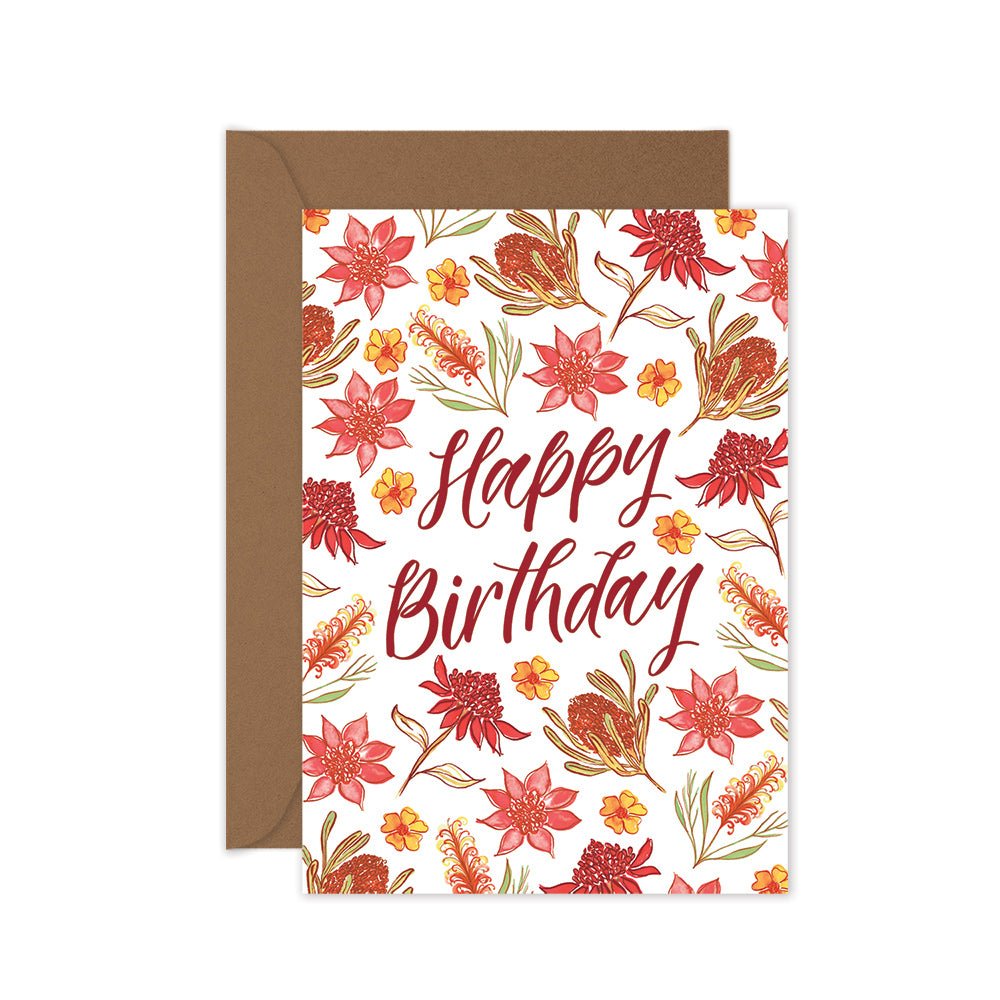 A birthday card with a red floral pattern and the text 'Happy Birthday' in the center. A brown kraft envelope is included.