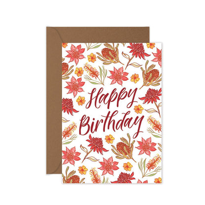 A birthday card with a red floral pattern and the text 'Happy Birthday' in the center. A brown kraft envelope is included.