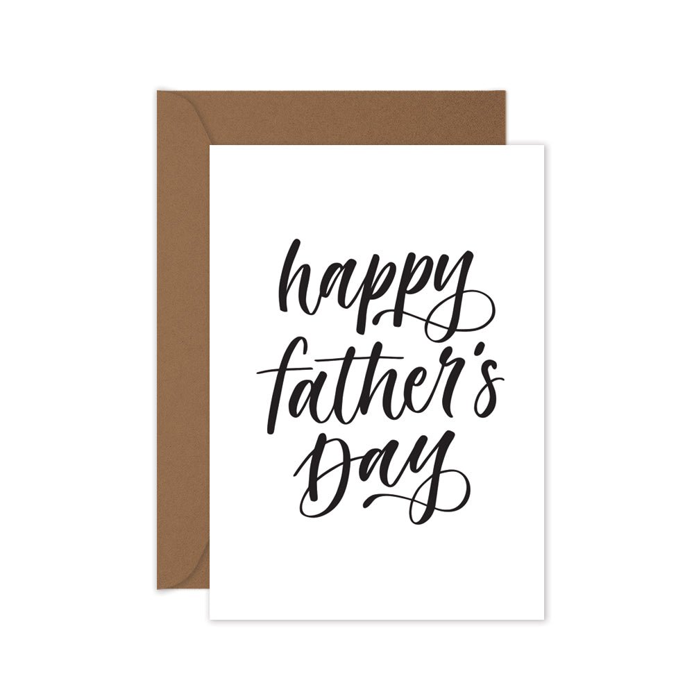 black and white happy fathers day greeting card on a brown kraft envelope