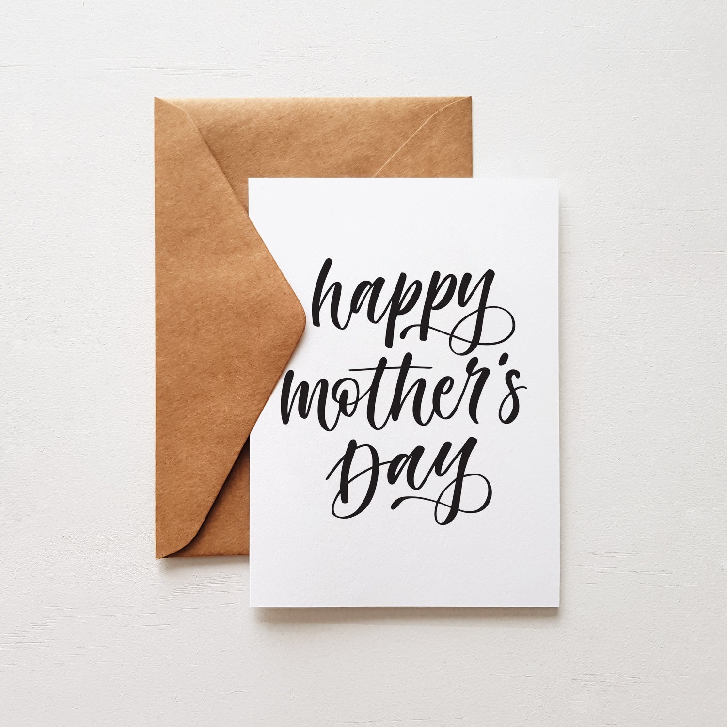 Happy mother's day card with black lettering and a brown envelope.