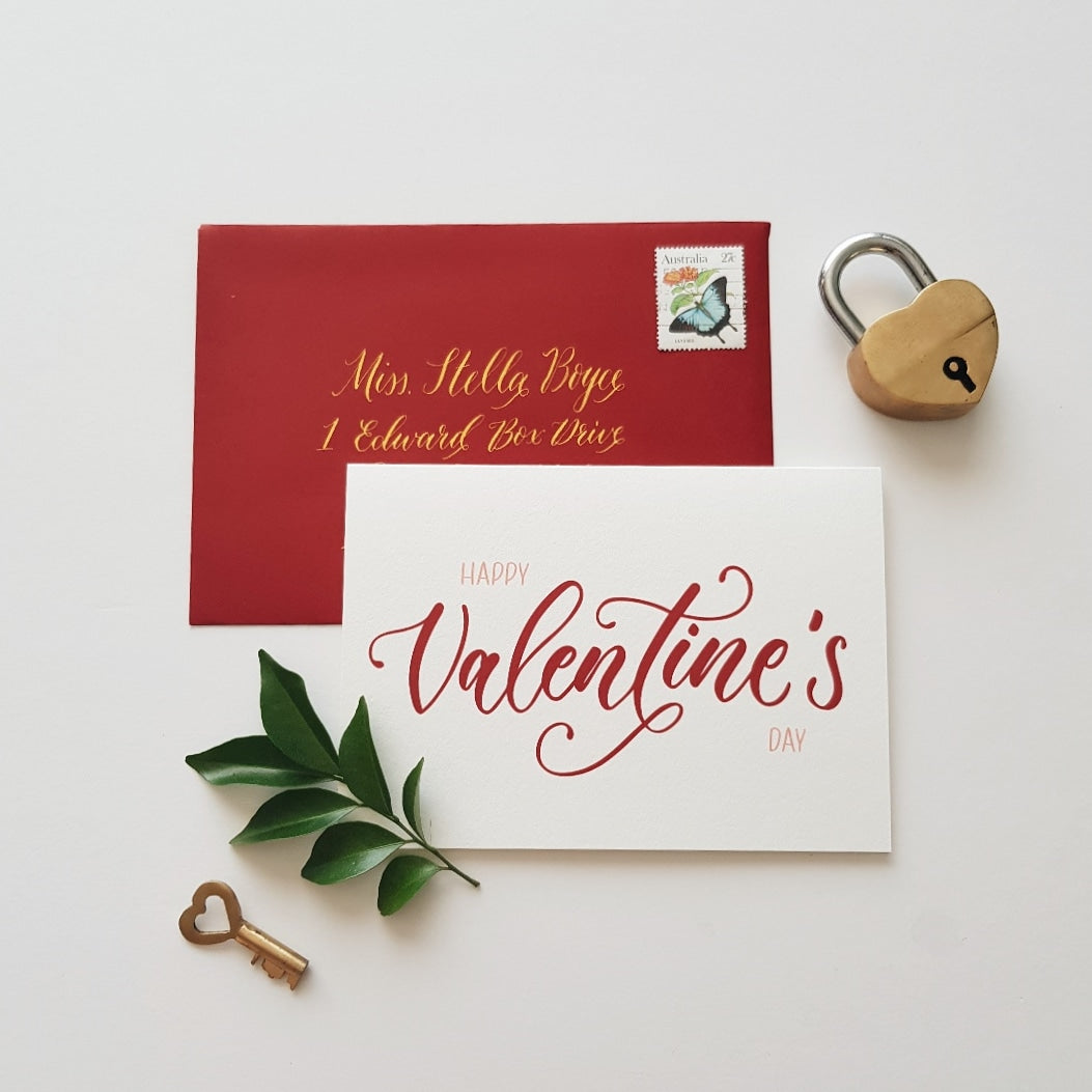 Happy valentines day card with a red adressed envelope, leaves, heart lock and key