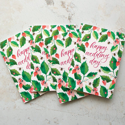 Three floral cards with 'happy wedding day' text on a textured surface