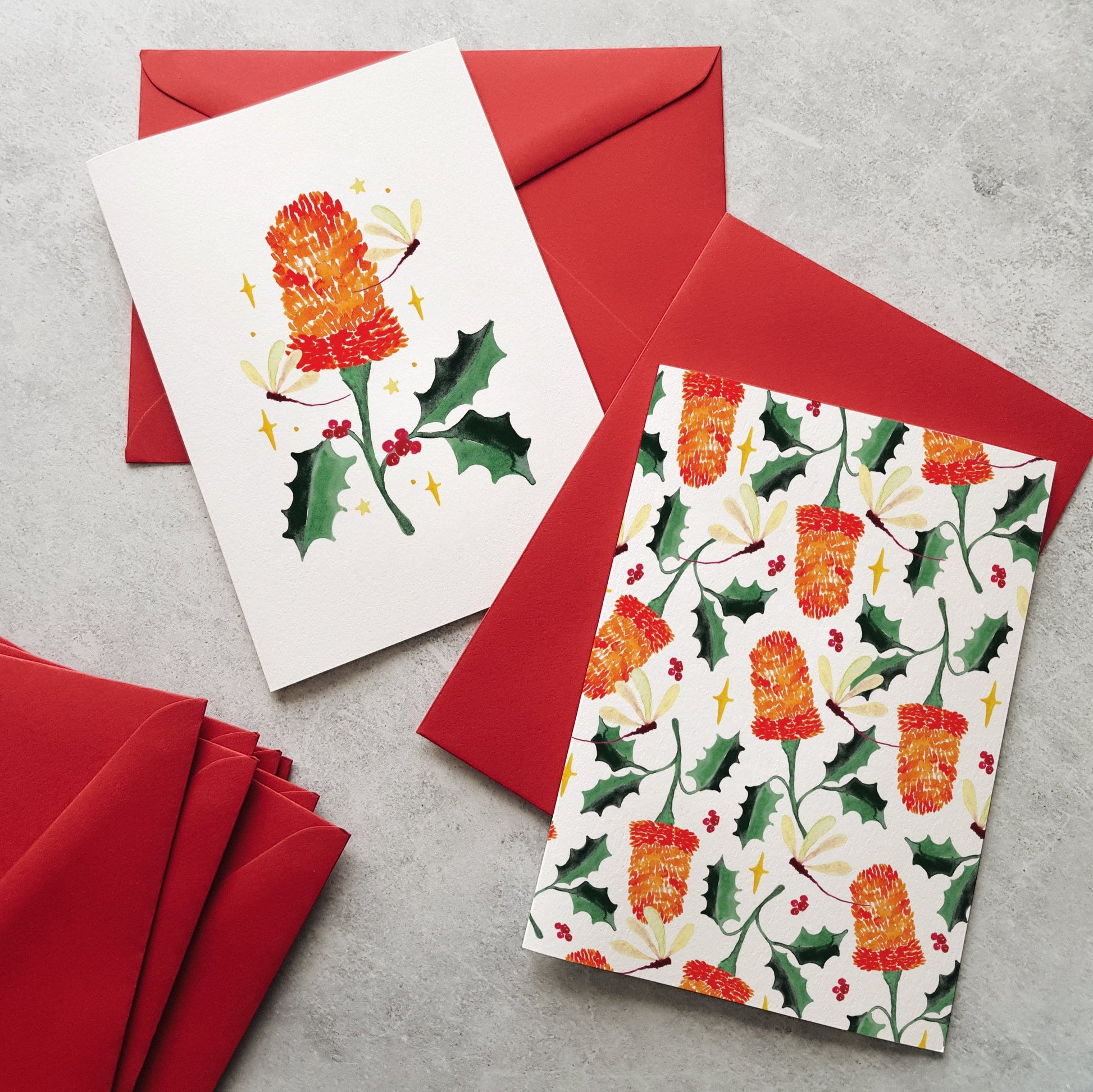 Two greeting cards with floral designs on red envelopes.