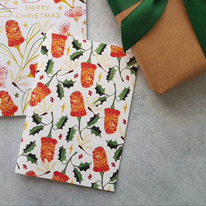 Banksias and holly leaves repeat pattern on a card on a marble background