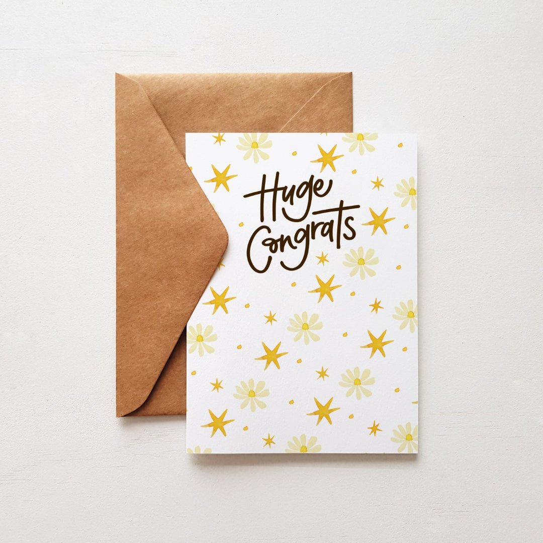 Huge Congrats greeting card featuring delicate daisies and yellow stars, paired with a kraft envelope.