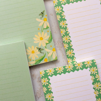 Teal DL notepada with a daisy design and lined pages, perfect for all your note-taking needs.