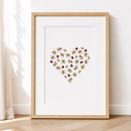 Framed artwork with a heart design of lady bugsand bees on a white wall.