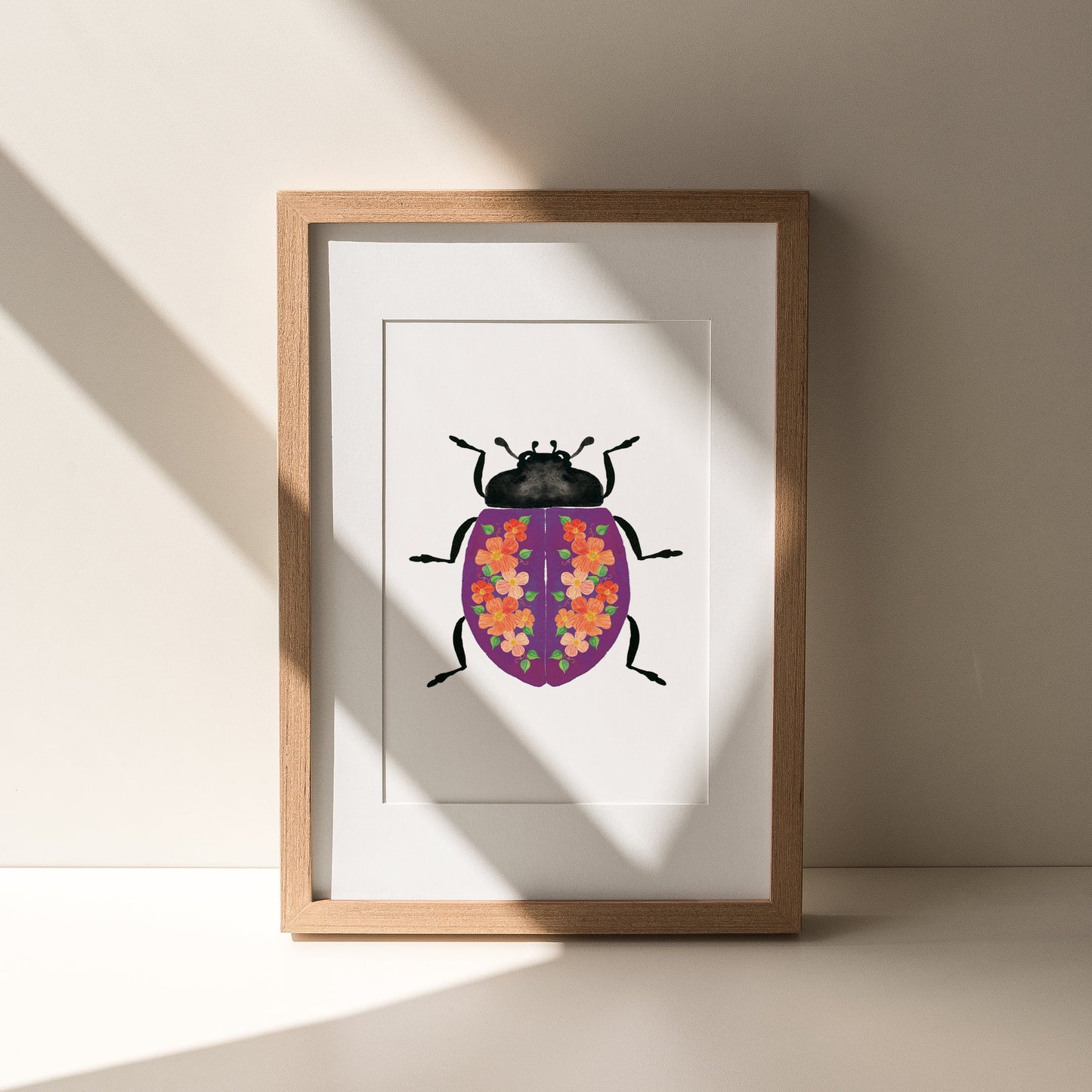 Wooden frame of a purple beetle with pink flowers on the shell