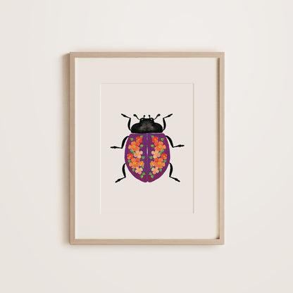 Purple lady beetle with floral pattern on shell in wooden frame
