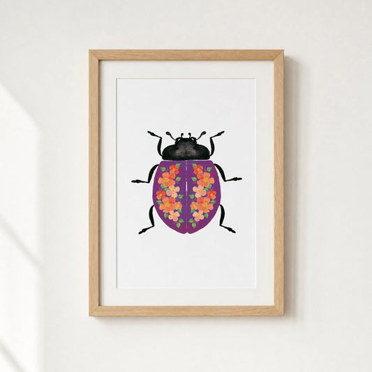 Framed artwork of a purple beetle with flowers on it's shell