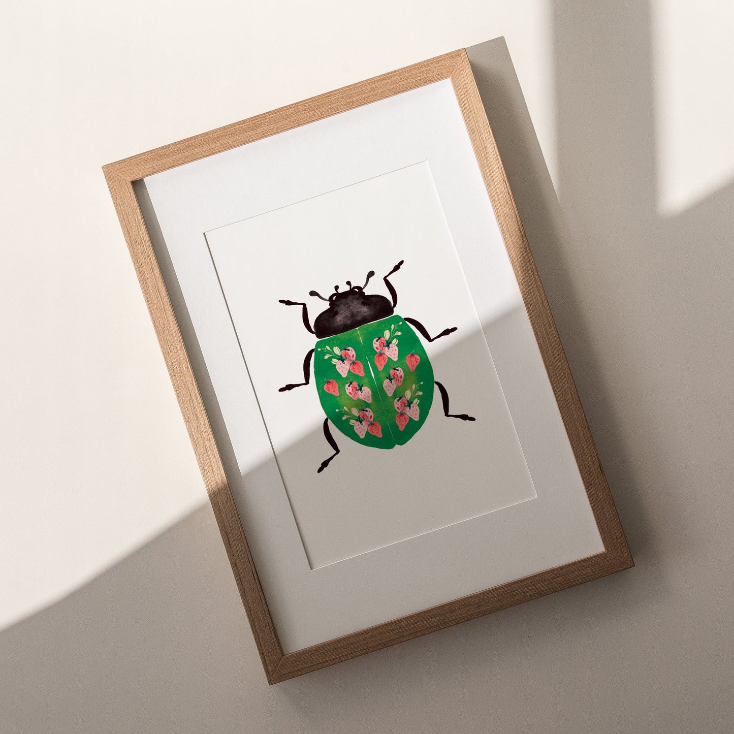 wooden framed green lady beetle with strawberry pattern