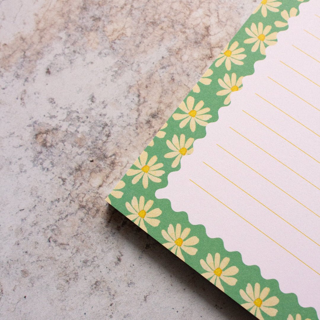 Notepad with floral design on a textured surface
