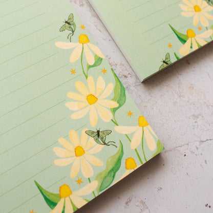 To do list notepad with floral design on a textured surface