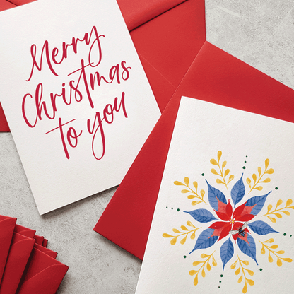 Christmas card with 'Merry Christmas to you' text and a poinsettia design on a red envelope.