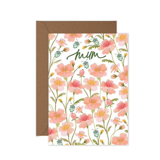 Floral card with 'Mum' text and brown envelope on white background