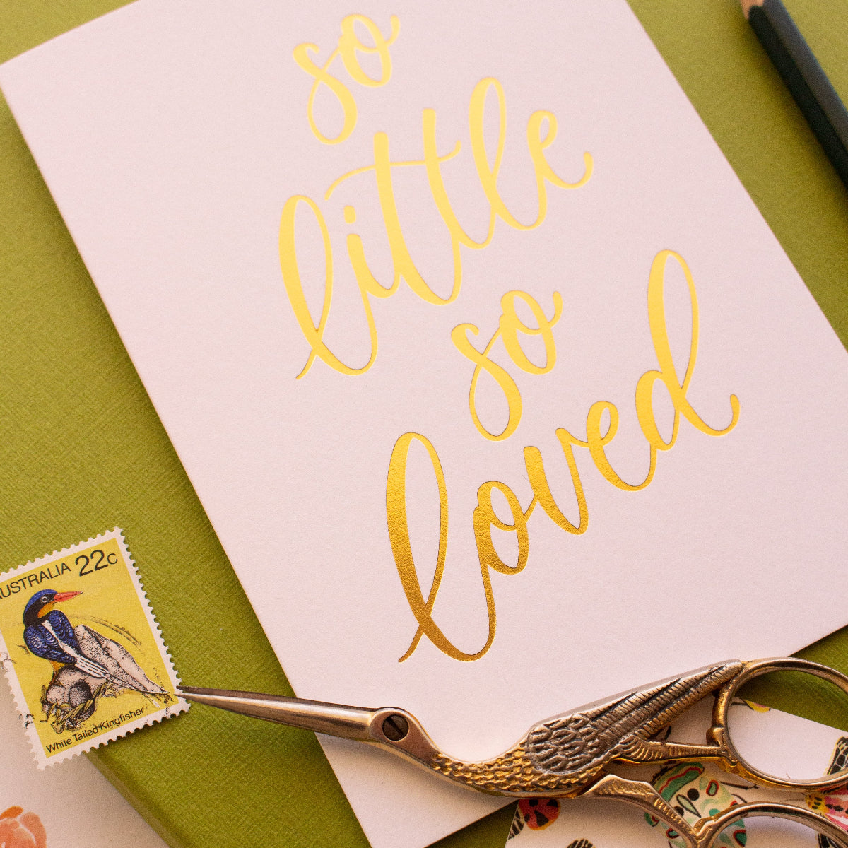 Close-up of hand lettered gold foil text on baby greeting card