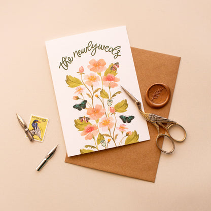 Newlyweds greeting card styled with envelope, stamp, wax seal and calligraphy nibs