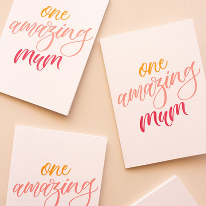 Four greeting cards with 'one amazing mum' text on a beige background