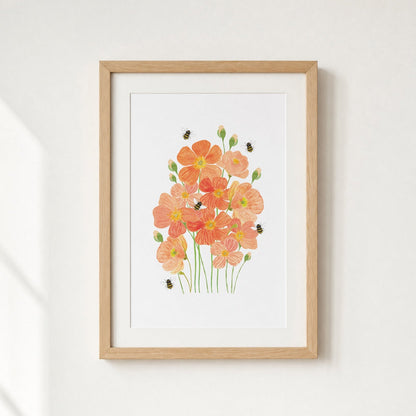 Framed artwork of orange flowers on a white wall