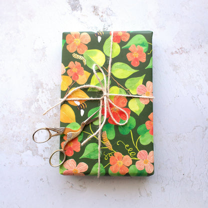 wrapped present with a tied brown string bow and golden bird scissors