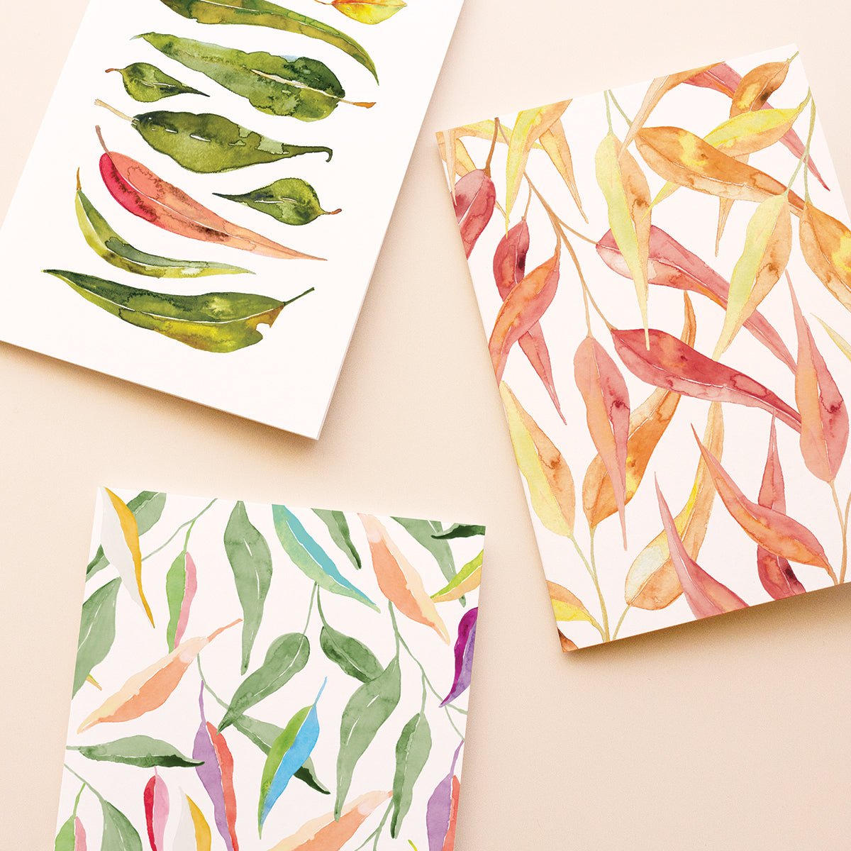 Colourful Australian gum leaf patterns cards against a beige background