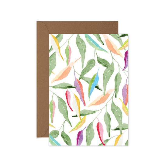 A folded greeting card with a colourful Australian gum leaf pattern and a brown kraft envelope.