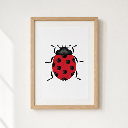 Framed artwork of a red ladybug with black spots on a white background