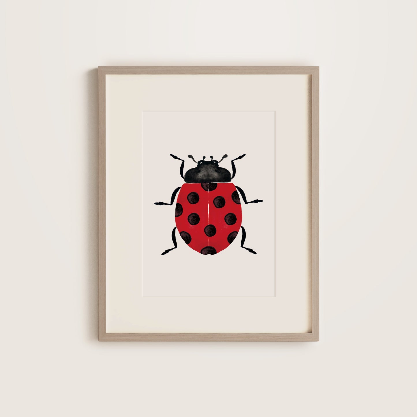 Framed artwork of a ladybug on a white background