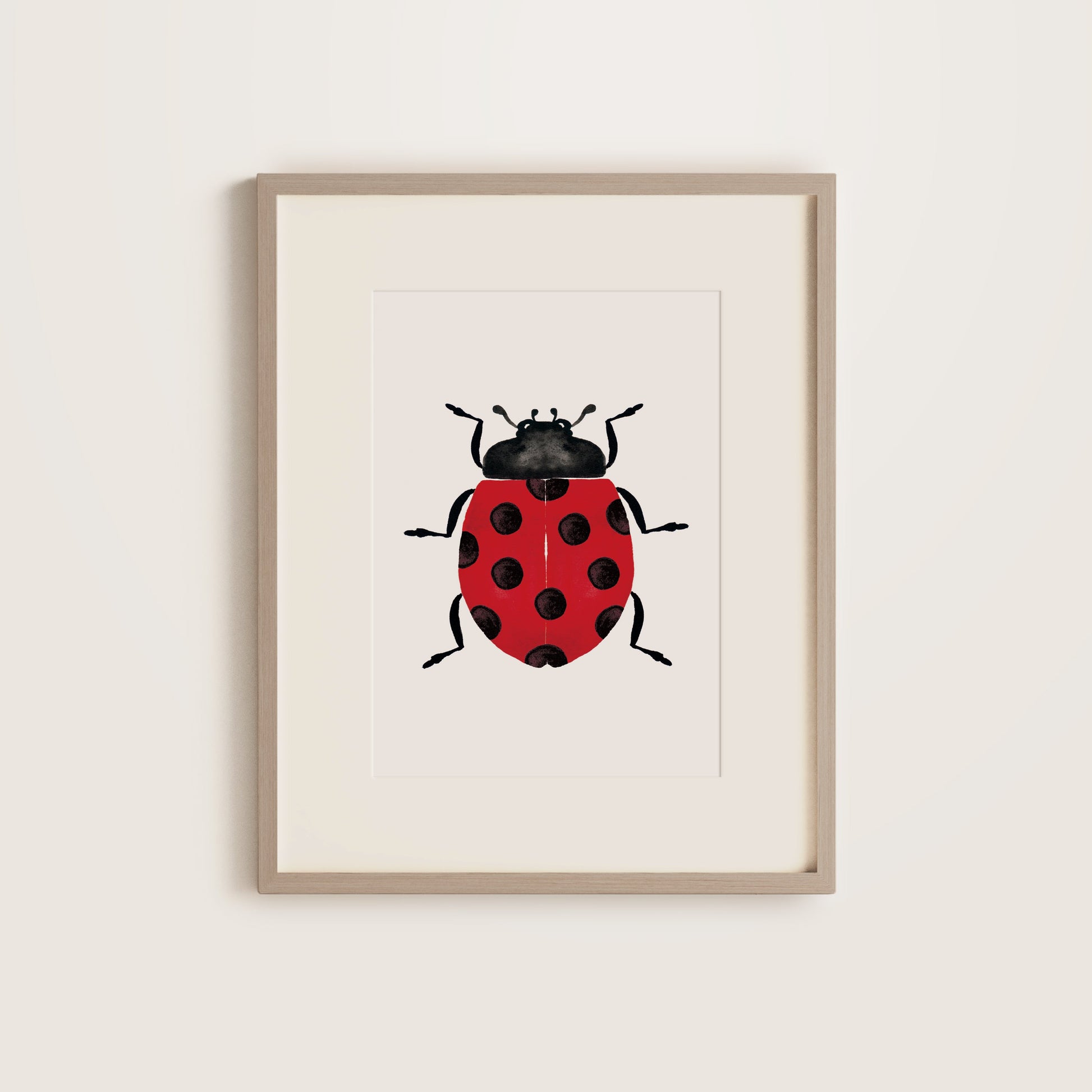 Framed artwork of a ladybug on a white background