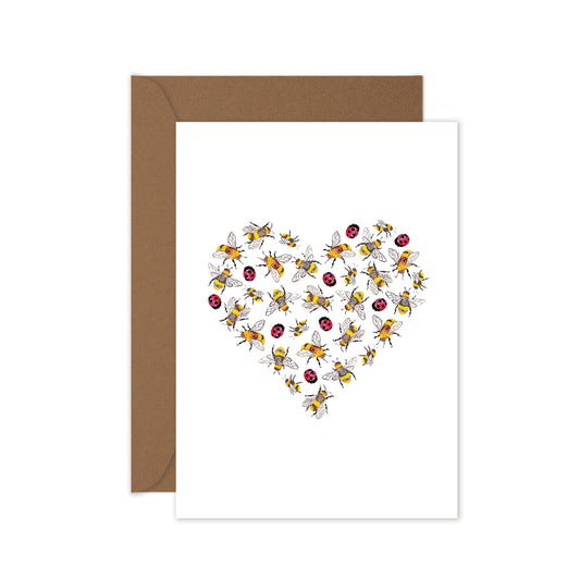 A greeting card with a design of ladybugs and bees forming a heart shape, accompanied by a brown kraft envelope.