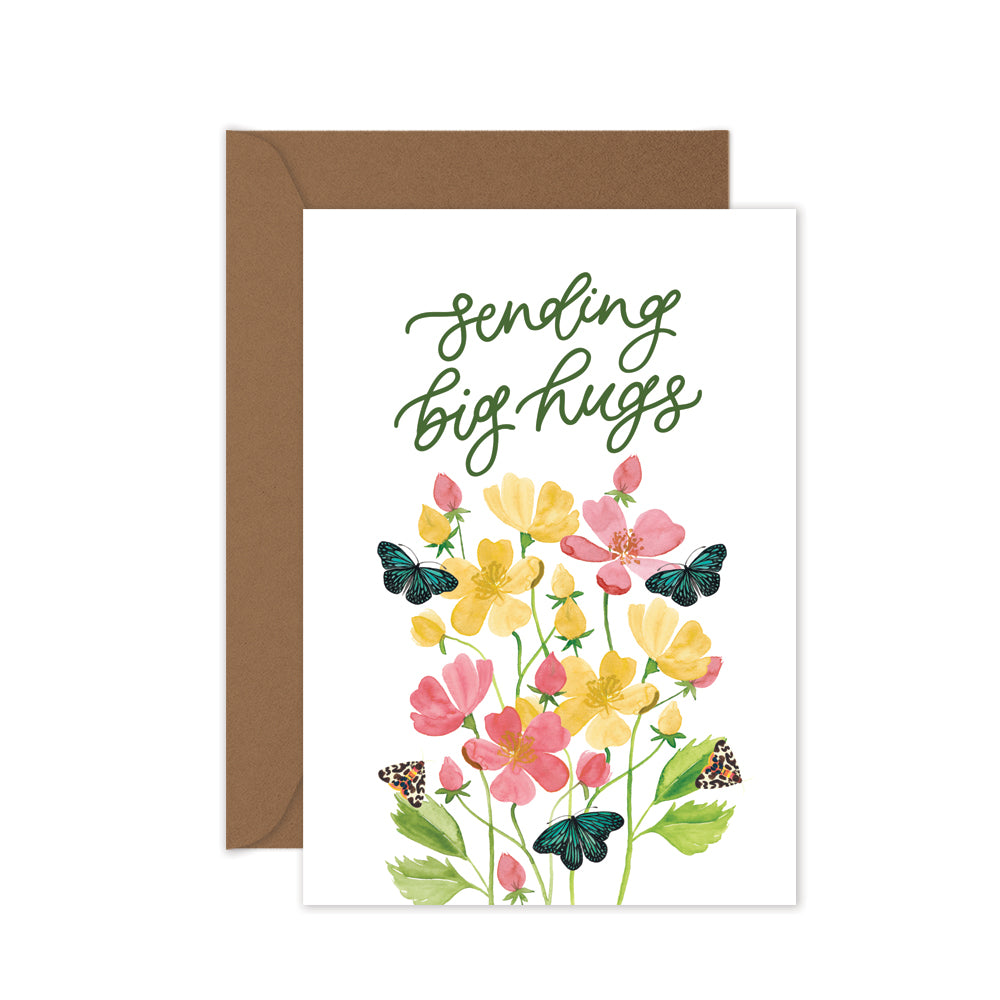 Greeting card with floral design and 'Sending big hugs' text, brown envelope.