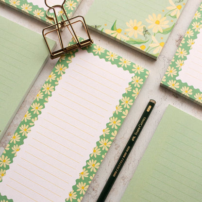 Charming teal DL notepads featuring a daisy design with lined pages for writing and journaling.