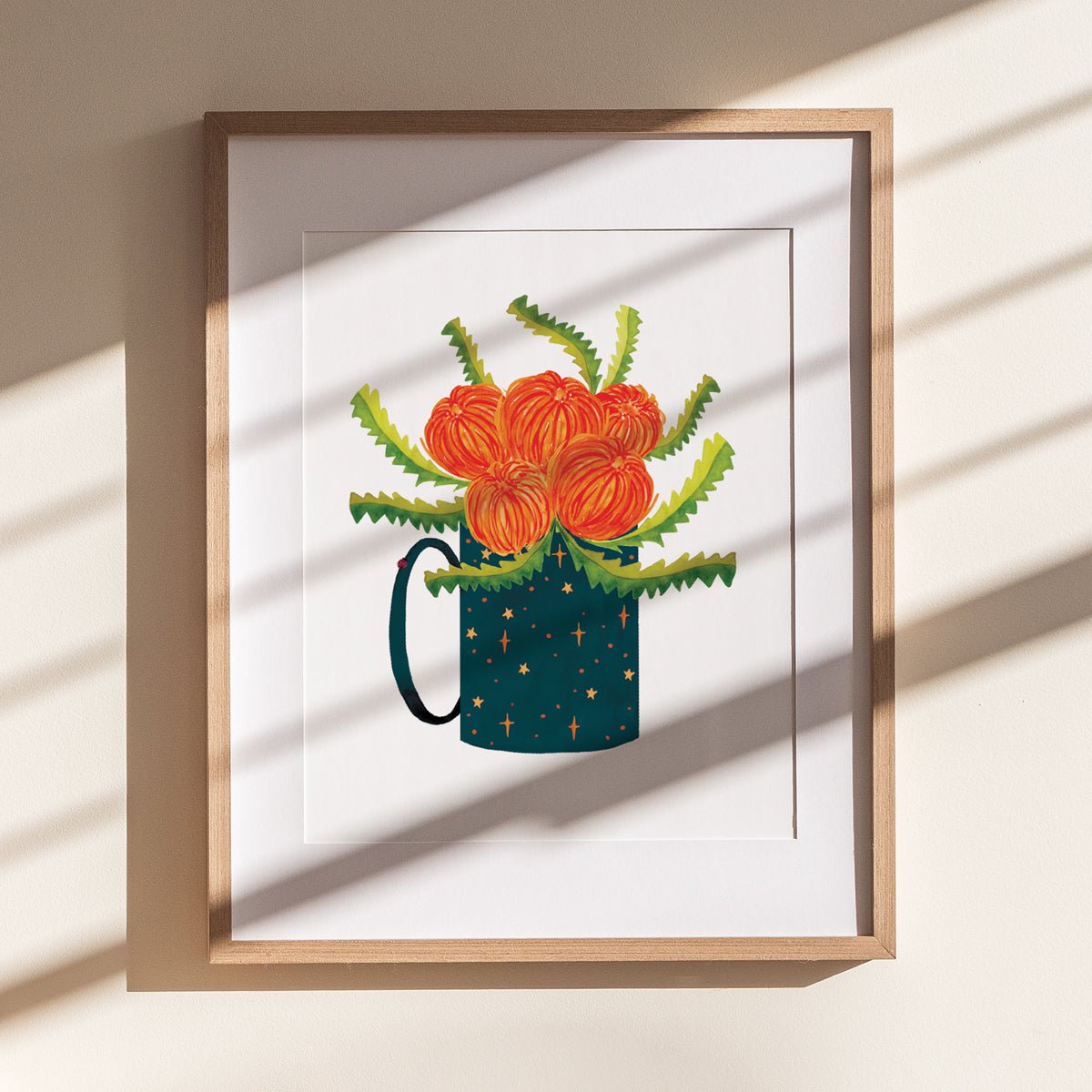 wooden framed print of red flowers, green zig zag leaves in a starry mug