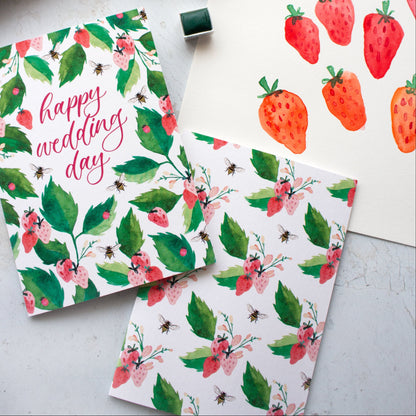 Floral and strawberry-themed stationery items on a light surface