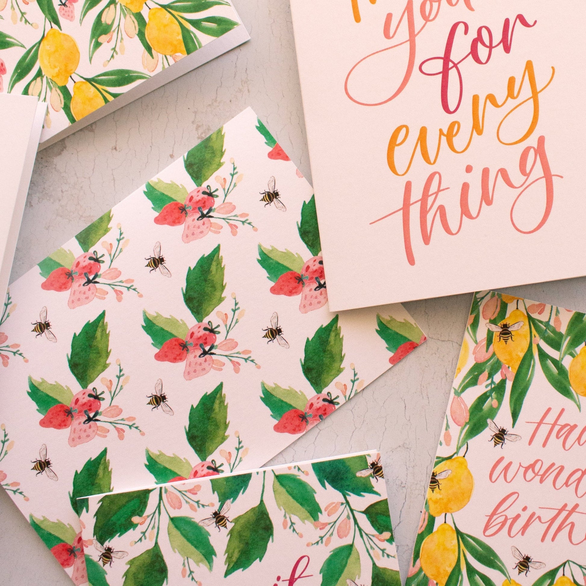 Collection of floral and nature-themed cards on a light surface