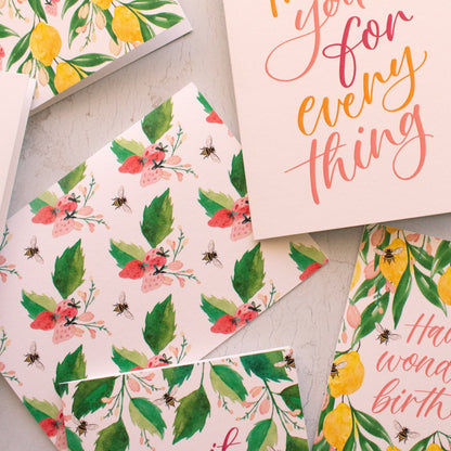 Collection of floral and nature-themed cards on a light surface
