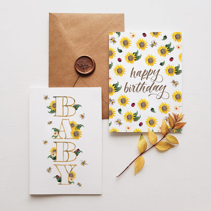 two sunflower greeting cards on a brown envelope with a wax seel and yellow leaves