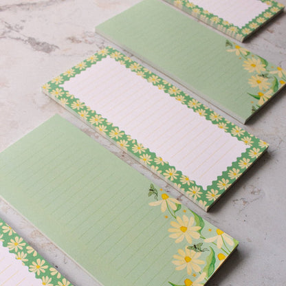Floral teal DL notepads with daisies and lines, ideal for everyday writing