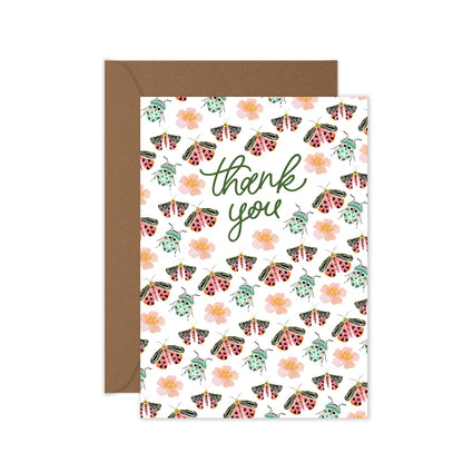 Greeting card with moth, beetle and flower  pattern and 'thank you' text, brown envelope.