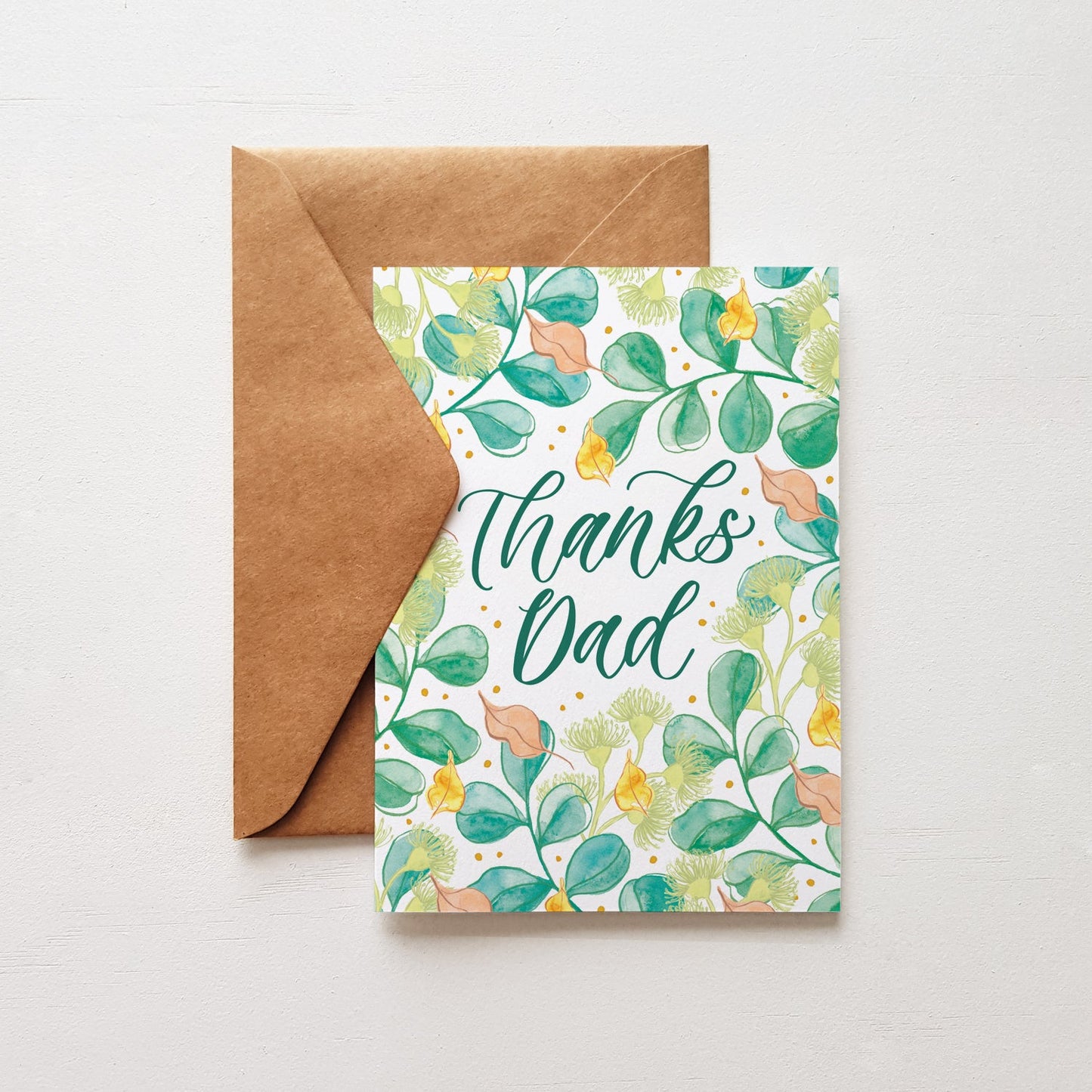 Greeting card design with green leaves and a hand lettered script that says 'thanks dad'