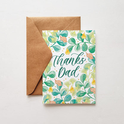 Greeting card design with green leaves and a hand lettered script that says 'thanks dad'