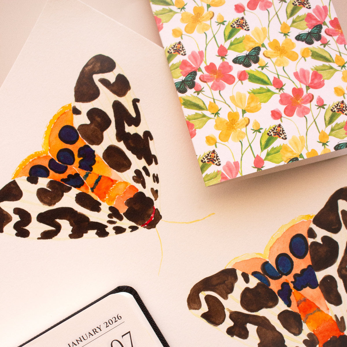 Calendar with floral and insect designs on a light background