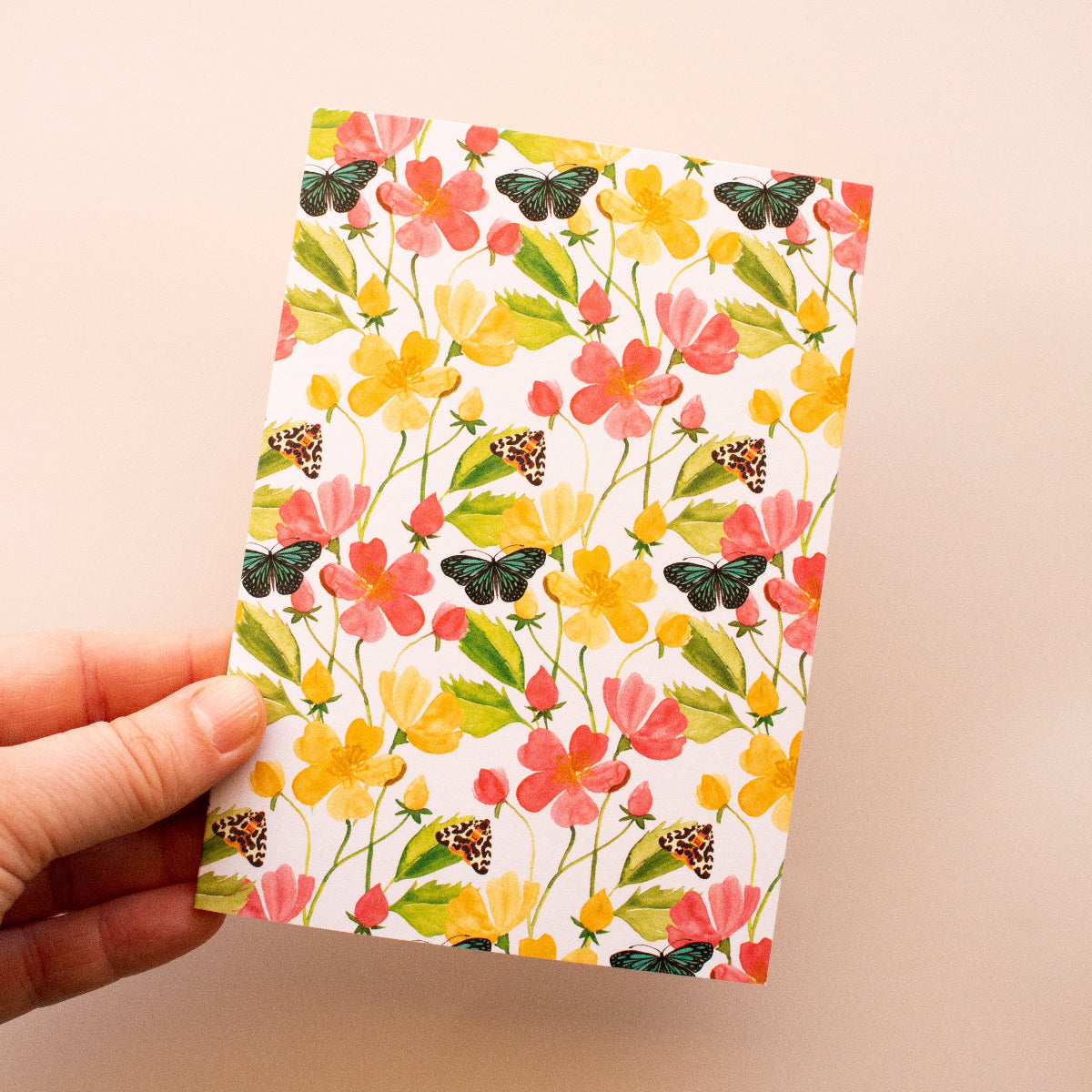 Greeting card with detailed illustration of butterflies and moths among garden flowers