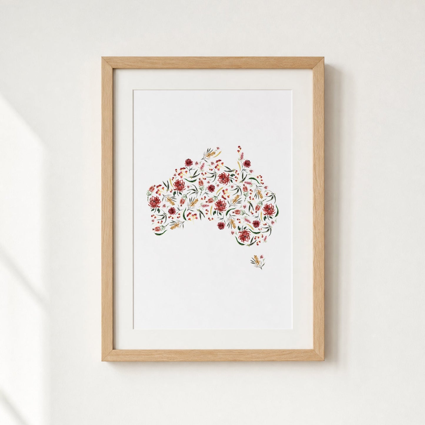 Framed artwork of a floral pattern of a map of Australia on a white background