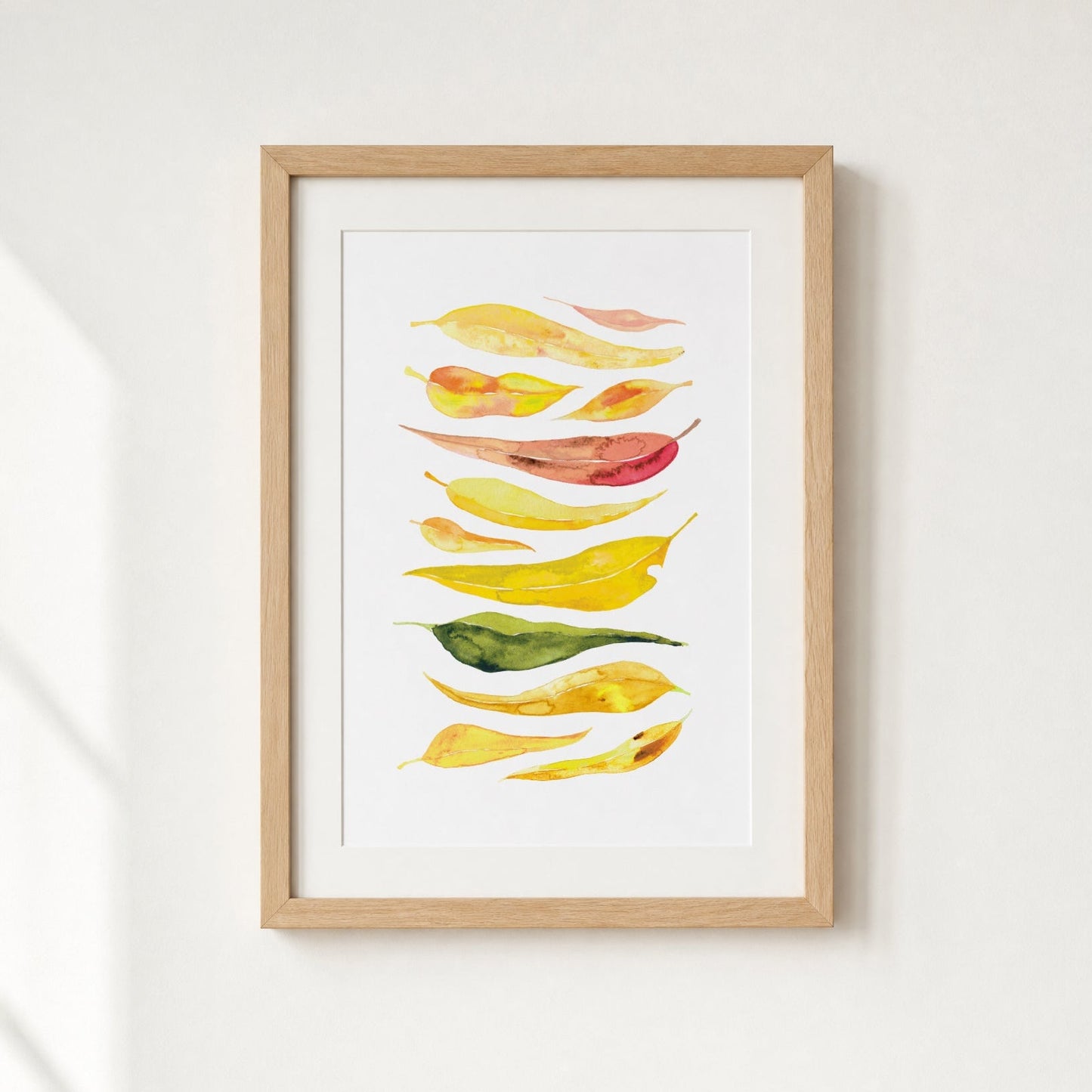 Framed artwork of colorful leaves on a white background