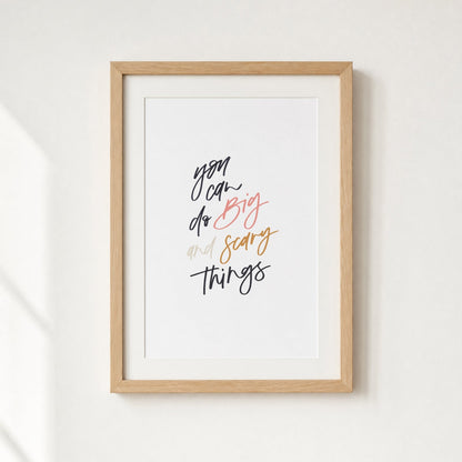 Framed print with motivational quote on a white wall