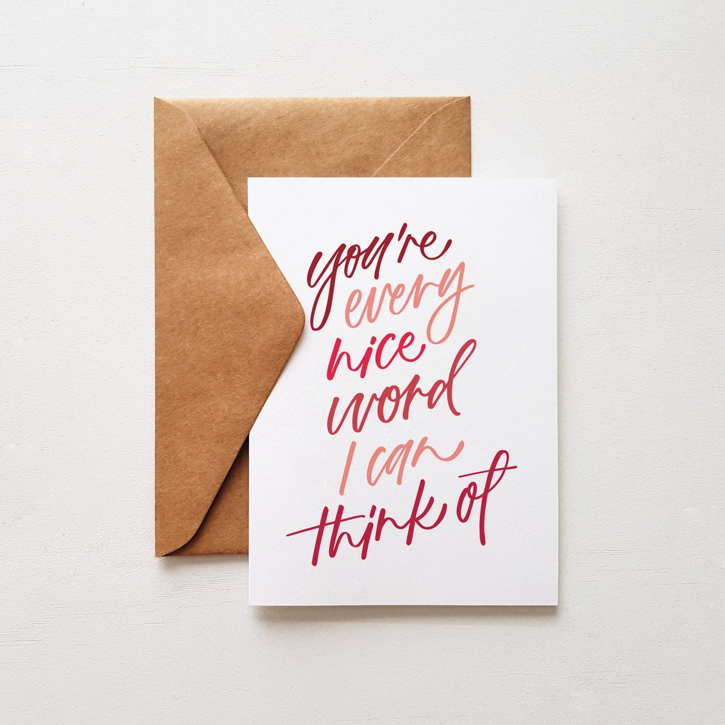 encouragement greeting card with 'you're evey nice word I can think of' in shade of pink and red