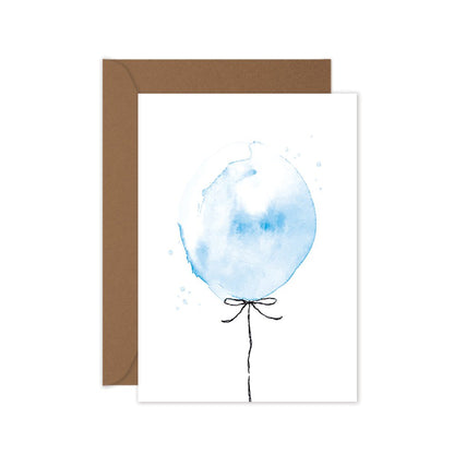 A greeting card with a hand painted blue balloon illustration, accompanied by a brown kraft envelope.