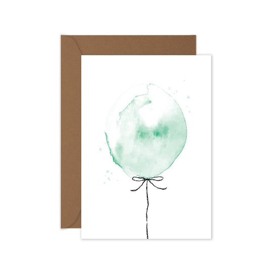 A folded greeting card with a hand-painted green balloon design, and a brown kraft envelope.
